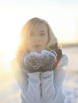 A young woman with snow on her hands