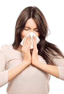 A woman blowing her nose