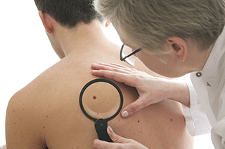 A man having his back examined by a doctor