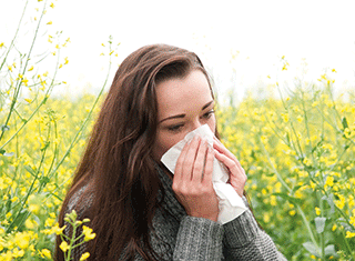 A photo of a woman sneezing