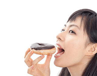 A photo of a woman eating a doughnut