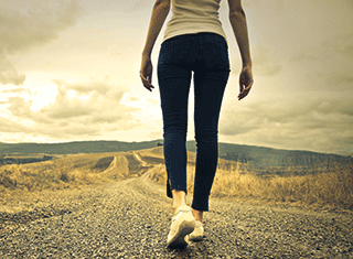 A photo of a woman walking in the countryside